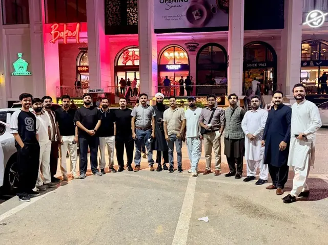 Tech professionals standing together outside a café at night
