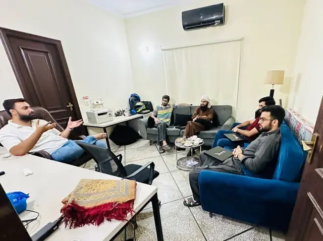 Small group in discussion in an office lounge