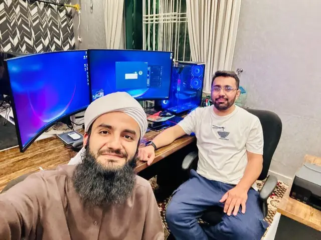 Owais Attari with a fellow technologist at a multi-monitor workstation