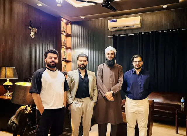 Four professionals standing together in a dark-panelled office