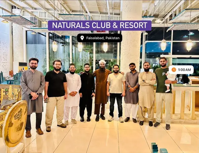 Nine professionals standing together in a resort lobby